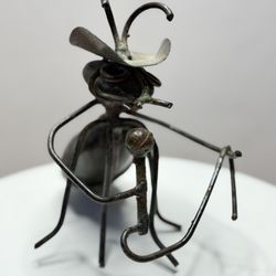 This sculpture is of a musician ant. 