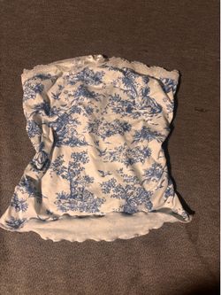 White strapless top with blue design and a bow