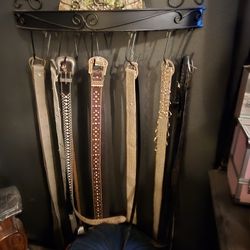 Wrought iron belt holder and a little over ten belts 