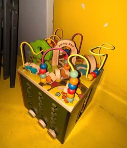 This is a B. toys Zany Zoo Activity Cube, a wooden educational toy designed for toddlers.