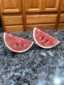 Ceramic Watermelon Slices Pair of Salt And Pepper Shakers.  Size appropriately 2 1/2 inches long, 1 inches wide and 1 1/4 inches tall.  Preowned the b