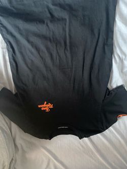 small orange and black true religon shirt