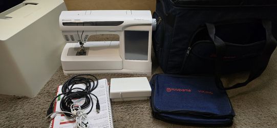 Professional-grade Husqvarna Viking Designer SE sewing and embroidery machine . Comes with a hard protective cover, a soft carrying case, and a blue a