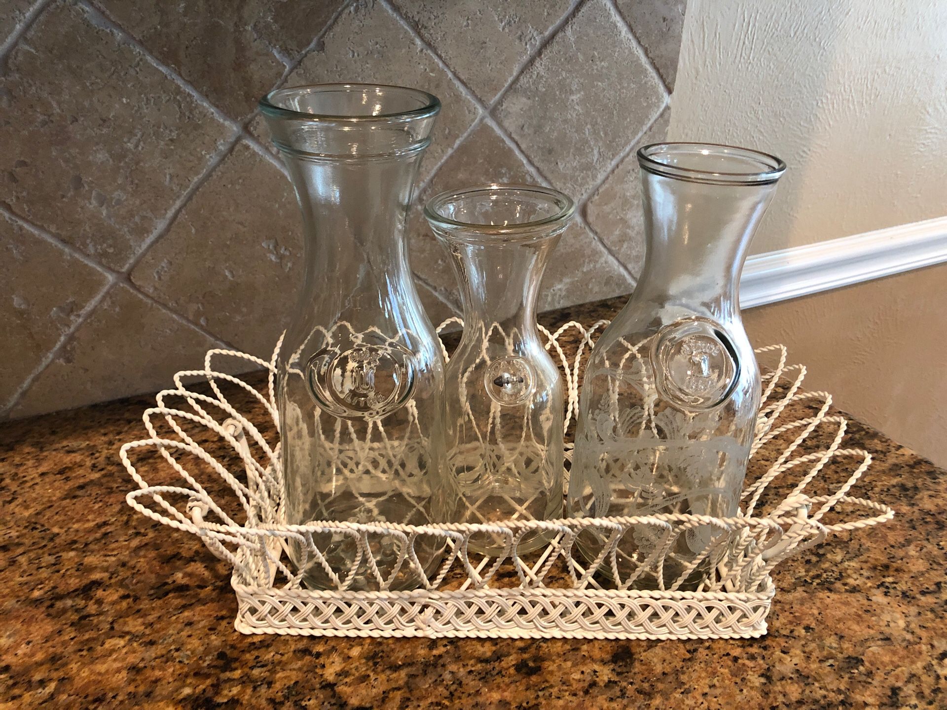 3 glass carafes in wire basket