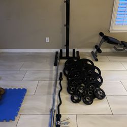 255lbs of rubber coated Olympic weights with 7ft 45lbs bar and weights tree plus curl bar like new