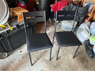 Two black dining chairs