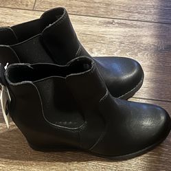 This is a pair of Maurices Chelsea wedge ankle booties in black faux leather