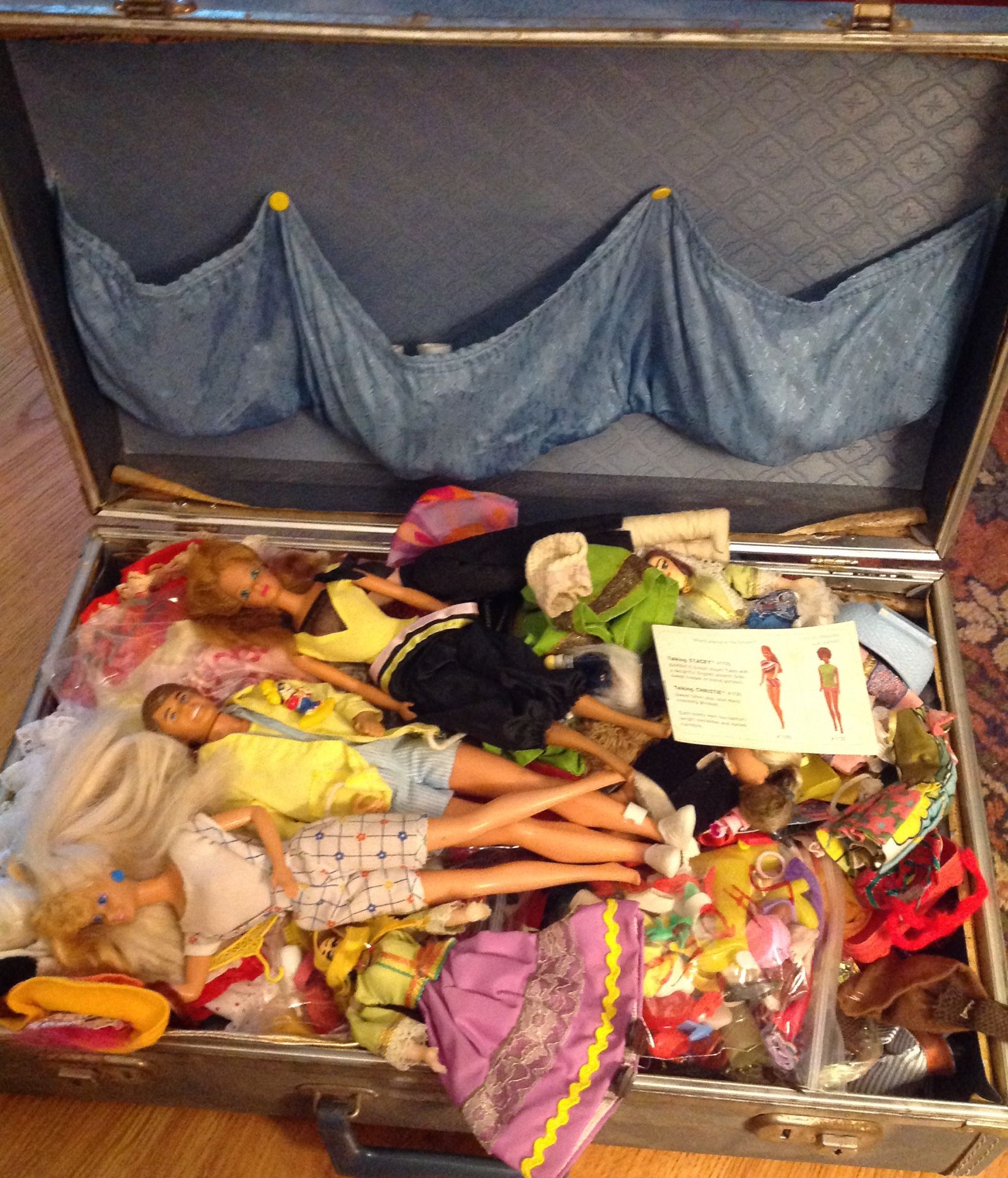Vintage suitcase full of dolls and clothes