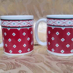 Two Vintage 1990 Houston Foods red and green coffee mugs with a Nordic pattern. 