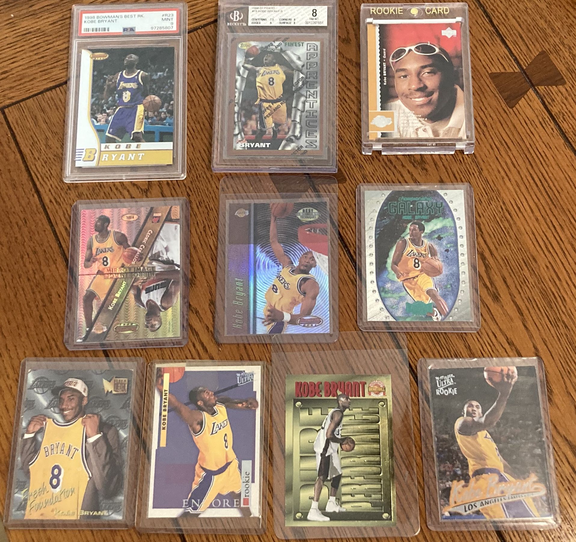 Lot Of 10 Kobe Bryant Cards with 1996 rookies, two refractors, PSA 9 and BGS 8 rookies, and inserts! Manufacturers include Topps Upper Deck Finest Bow