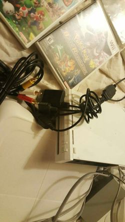Huge nintindo wii bundle with fit board and some games numchuck charger wheels zapper