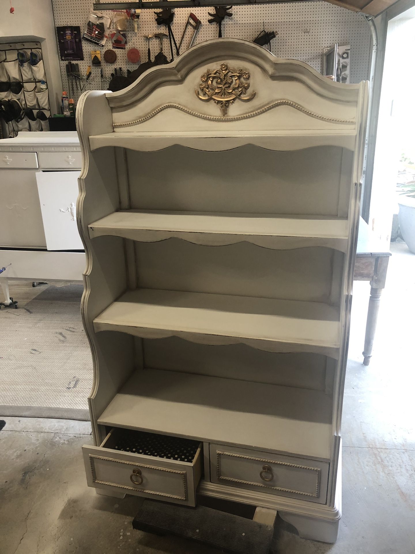 White painted bookcase with lined drawers