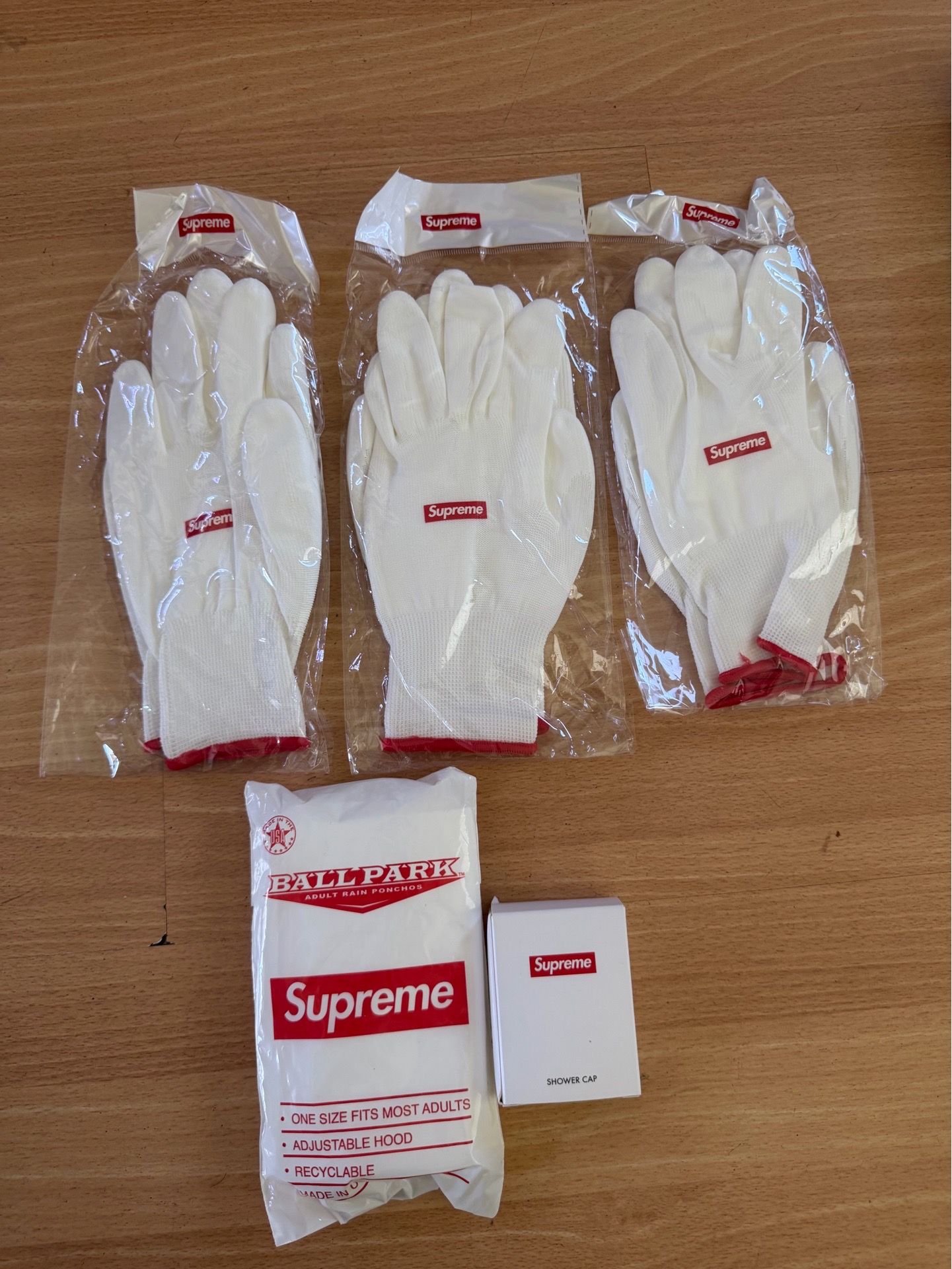 Supreme 3x rubberized gloves, supreme poncho, and supreme shower cap
