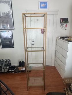 Gold colored metal bookshelf