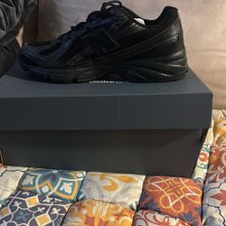 All black New Balance 740 