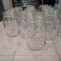 16 mason jar mugs with handles.