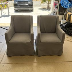 Two Gray Slip covered Chairs