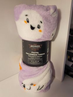 soft pastel purple and white ghost-patterned Halloween throw blanket