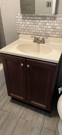 Used 24 inch complete bathroom vanity with sink and fetal faucet.