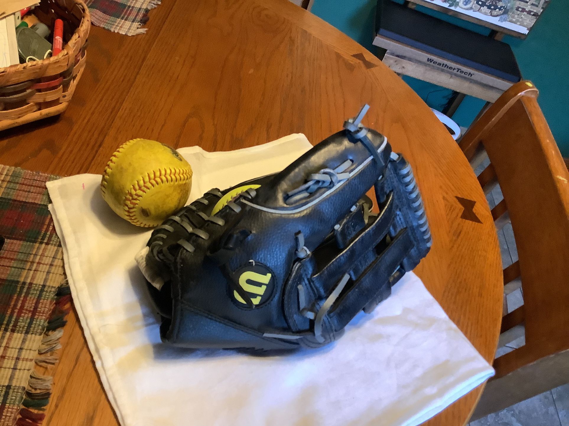 Wilson oversized 13” softball glove like new condition correctly broken in model A2477 adjustable wrist comes with 2 softballs Perfect for adult or te