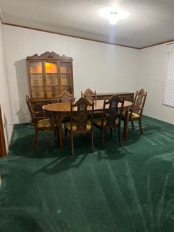 This dinner set matching chairs and a china cabinet.