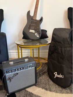BLACK AND GOLD FENDER ELECTRIC GUITAR - LIKE NEW
