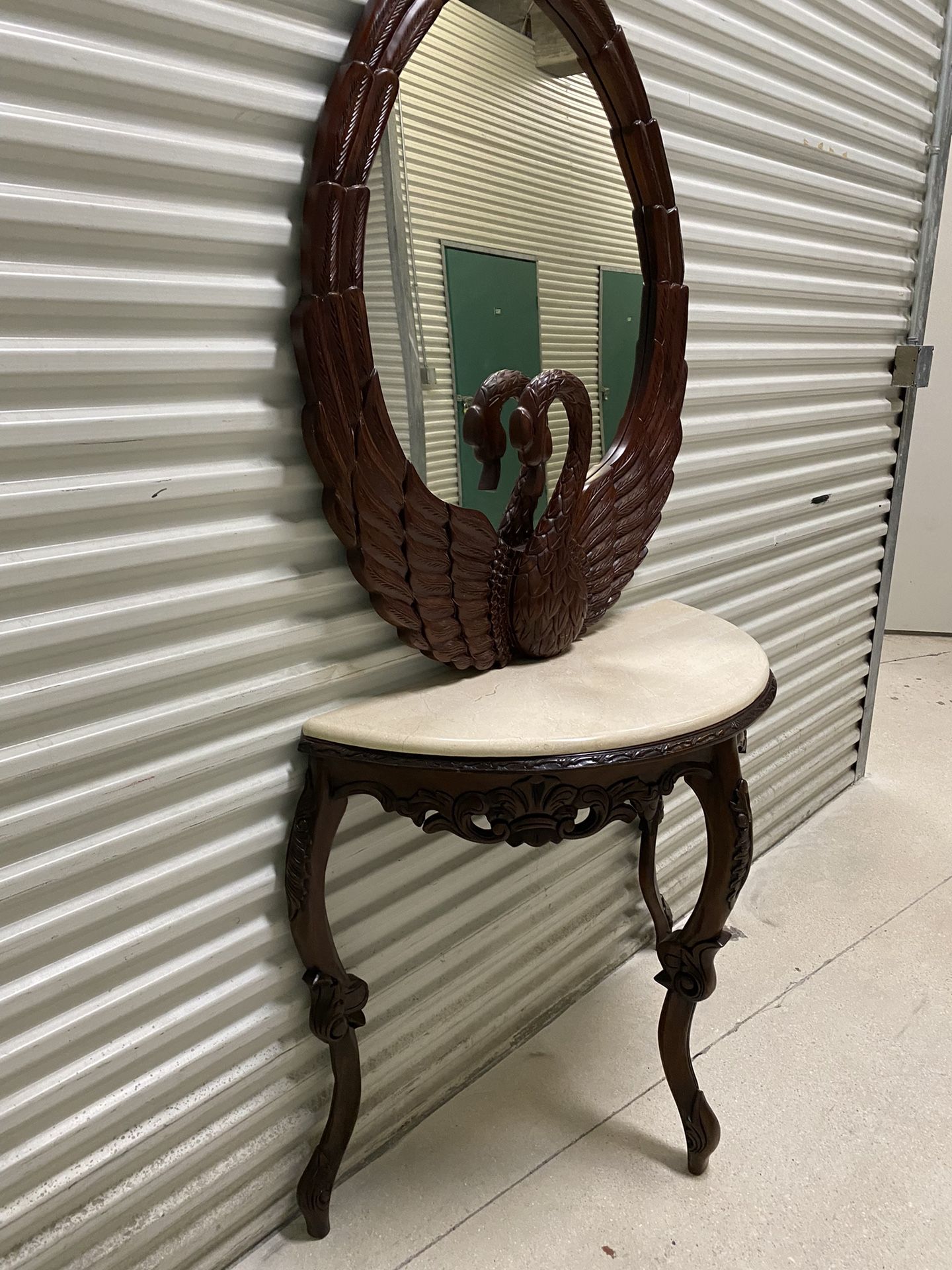 Hand carved Swan wall mirror features sculptural swan carving and a deep rich finish