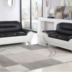 The set is designed with a modern minimalist style and is upholstered in top-grade bonded leather for a smooth, easy-to-clean surface. The set also fe