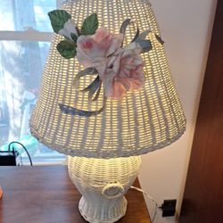 White wicker table lamp with fabric flowers and ribbons