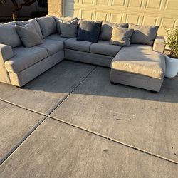 GRAY REVERSIBLE CHAISE SECTIONAL BY LIVING SPACES , DELIVERY INCLUDED