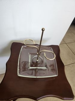 Elegant glass jewelry holder with metal stand.