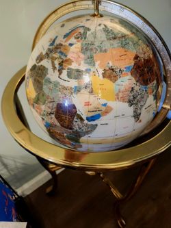 Mother of pearl and gemstone globe in brass tripod stand