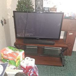 Fifty five inch samsung smart t v with t v stand and new ruku soundbar