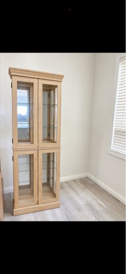 curio cabinet with glass and lights
