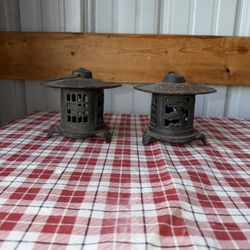 Japanese cast iron pagoda lanterns. They don’t have bottoms/candle holders inside. There are no doors on them that open up. They have rust from age se