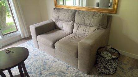 Beige or tan  loveseat and couch