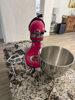The kitchenAide Artisan Series 5 Qt Stand Mixer Model (KSM150PSCB) in Cranberry is a 10-speed, tilt-head electric mixer featuring a 5-quart stainless 