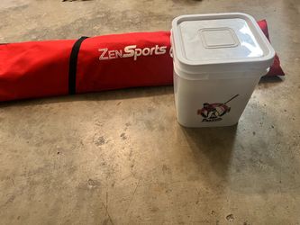 Softball net and bucket of softballs