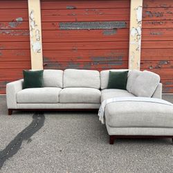 Gray Living Spaces sectional sofa couch with right facing chaise