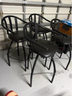 Four tall black barstools