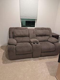 Two-Seater recliner with cup holders.