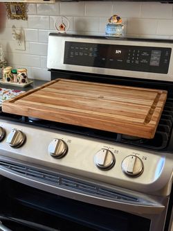 Teak cutting board over stove