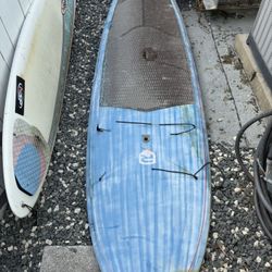 Surfboard And Paddle Board With Storage Brackets To Store 