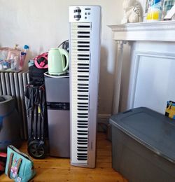 This is an M-Audio Keystation 88es USB MIDI controller, known for its silver finish and 88 semi-weighted keys.