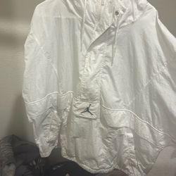a Jordan brand white windbreaker jacket, often referred to as the Jumpman Classics or Wings model. 