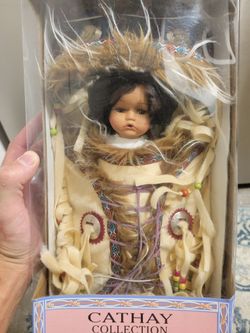Is Porcelain Doll with Certificate of Authenticity.
