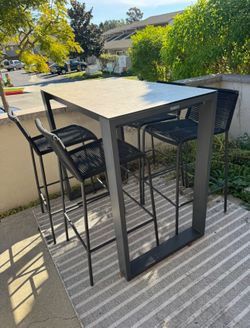 Terra Ventura 48" Bar Table in Charcoal - Ceramic-Style Glass Top outdoor table and Article chairs