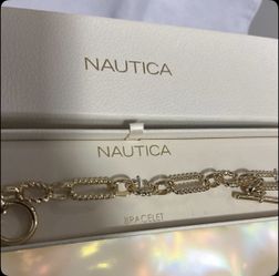 Nautica Gold-tone chain link bracelet with a toggle clasp. 