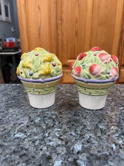 Ceramic Provence Garden pair of salt and pepper shakers.  Brand Studio Nova.  Size approximately 2 1/4 inches tall.  Brand new never used.