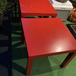 Two red matching end tables 